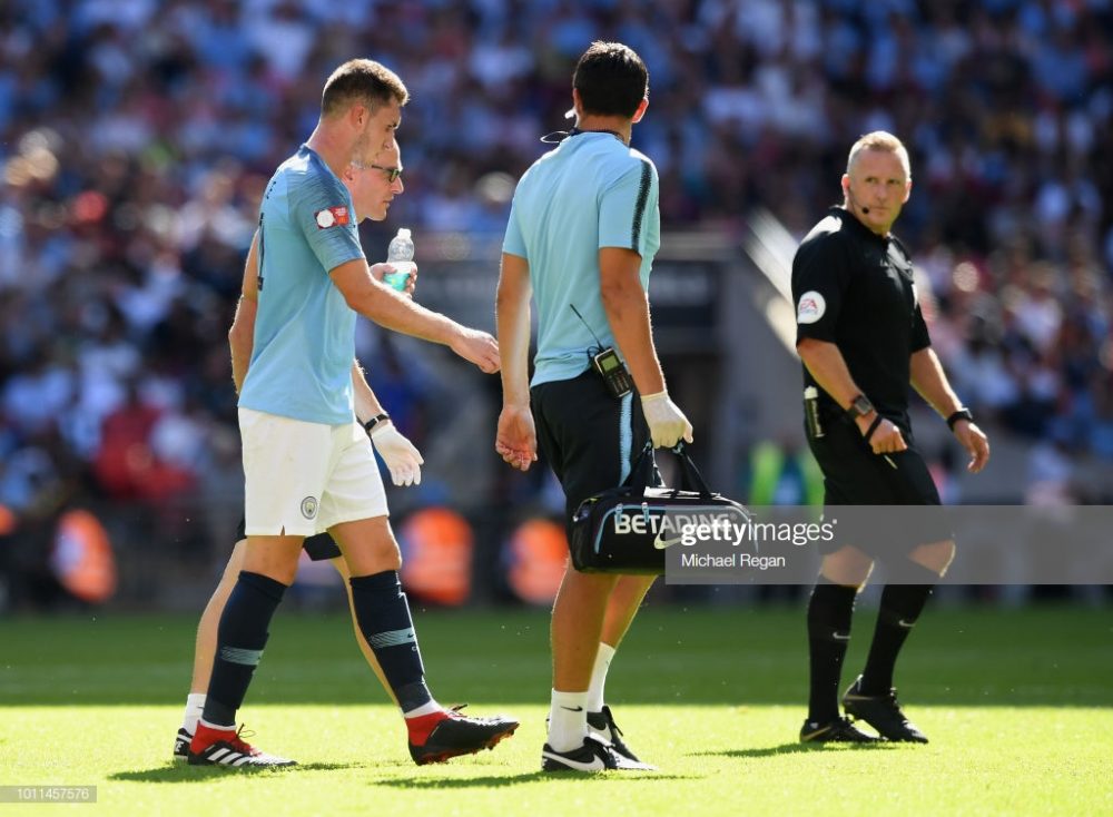 Aymeric Laporte of Manchester City leaves the field injured