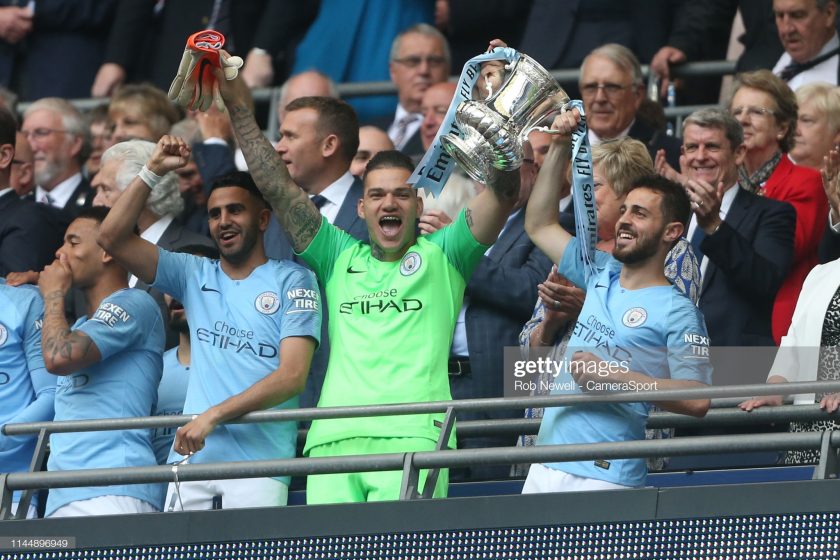 Manchester City's Ederson and Bernardo Silva with the trophy during the FA Cup Final matchc
